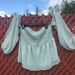 Sleeves are off the shoulder in this stylish ladies mint/sage green colored top.